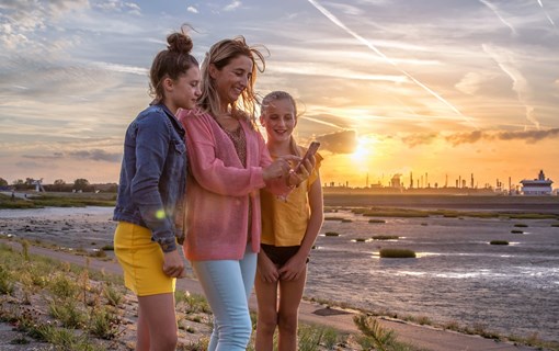 Family out and about at sunset in Terneuzen