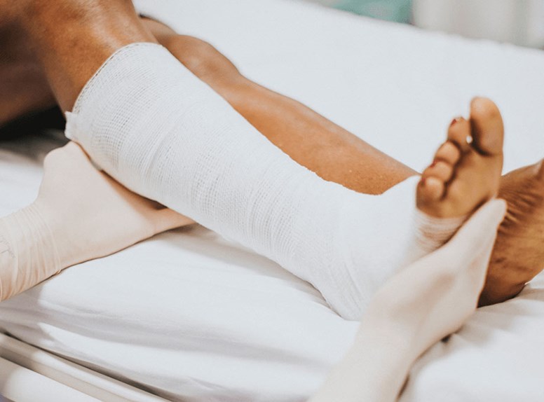 Healthcare professional caring for a patient with a leg in a cast