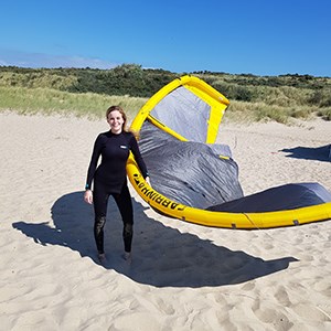 Vrouwelijke kitesurfer op het strand